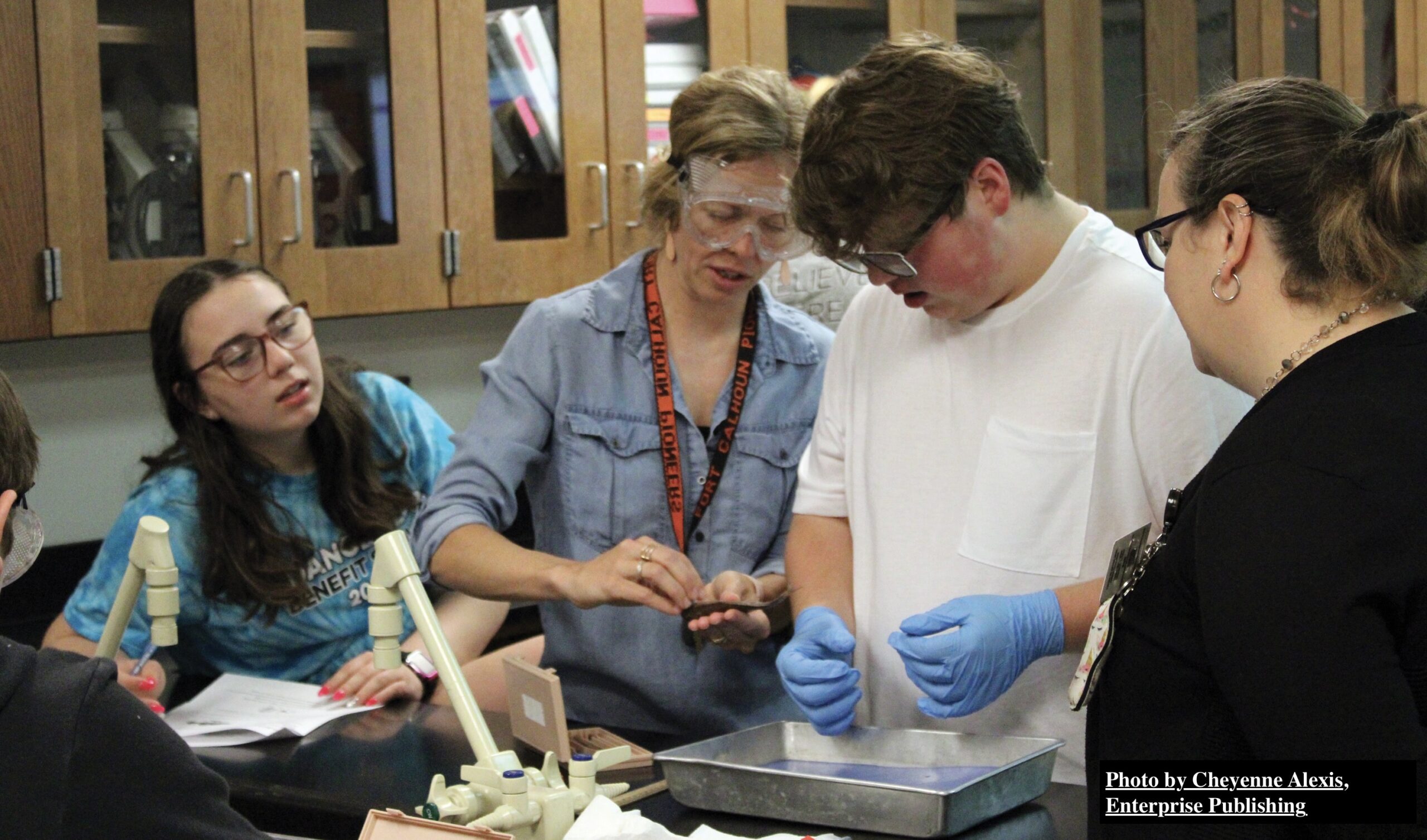 From left, Jordin Woebecke, Ashlie Nelson, William Anderson and Michelle Doyle examine a perch prior to dissection.